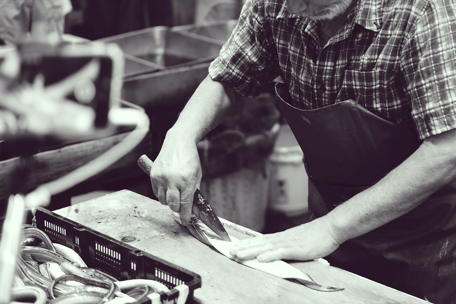Photo by Erica Leong grayscale photography of man using knife